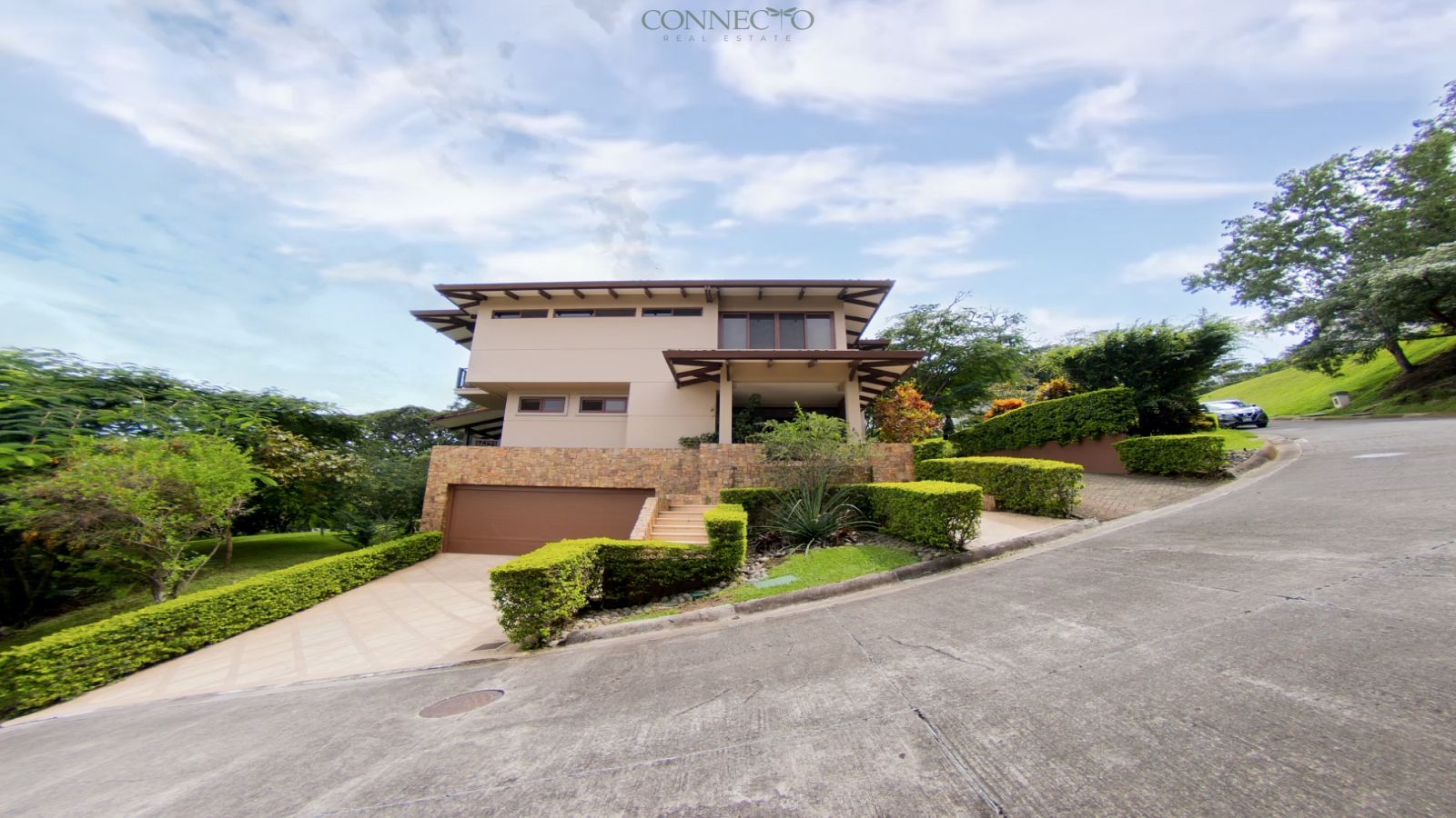 warm modern home with natural elements, home with natural stone and wood details, exposed wood beams home, home with beautiful gardens, natural light-filled home, luxury home with natural views, elegant modern social spaces, home with sunset views, contemporary organic design home.