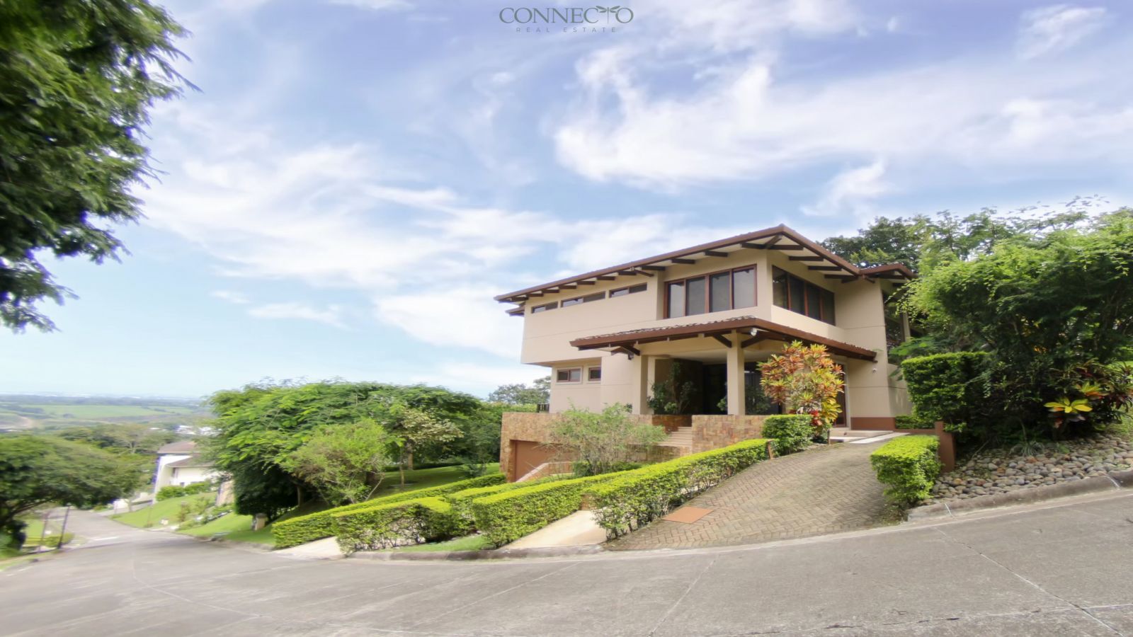 warm modern home with natural elements, home with natural stone and wood details, exposed wood beams home, home with beautiful gardens, natural light-filled home, luxury home with natural views, elegant modern social spaces, home with sunset views, contemporary organic design home.